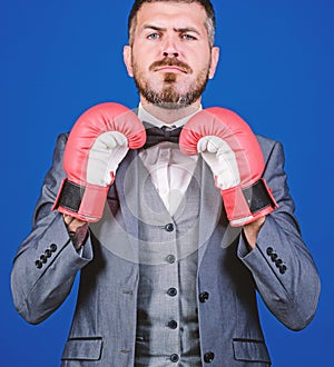 Business coach. businessman in formal suit and bow tie. bearded man in boxing gloves punching. Business and sport