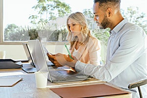 Business colleagues analyzing paperwork while working together in the office