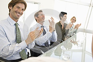 Business Colleagues Applauding In Conference Room