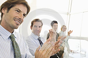 Business Colleagues Applauding In Conference Room