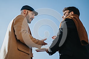 Business colleagues in casual attire having an informal meeting under blue sky. Focus on collaboration and partnership