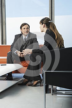 Business Colleagues Communicating In Office Lobby