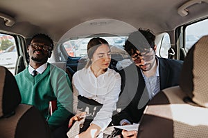 Business colleagues commuting together in a car discussing work