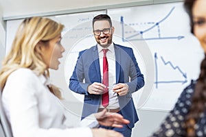 Business colleagues in conference meeting room during presentation