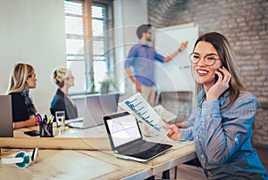 Business colleagues in conference meeting room during presentation