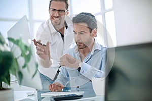 Business colleagues discussing business issues near the desktop