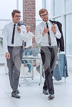 Business colleagues discussing something, walking in the office