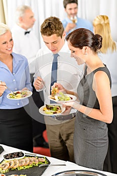 Business colleagues eat buffet appetizers