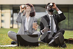 Business colleagues and friends. Cheerful businessman and businesswoman drinking take out coffee