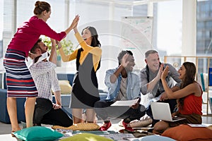 Business colleagues giving high five to each other