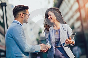 Business colleagues greeting each other outdoors