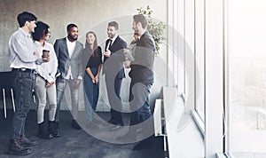 Business colleagues having coffee break near window