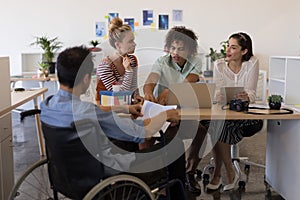 Business colleagues interacting with each other in office