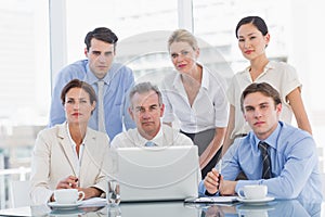 Business colleagues with laptop at desk