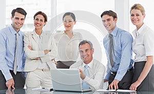 Business colleagues with laptop at desk