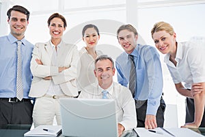 Business colleagues with laptop at desk