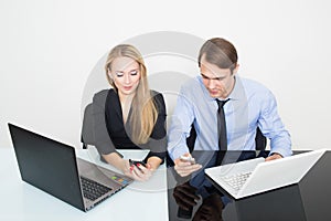 Business colleagues with laptop and digital tablet in meeting at office desk.