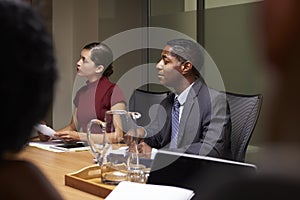 Business colleagues listening at boardroom meeting, close up