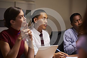 Business colleagues listening at evening meeting, close up