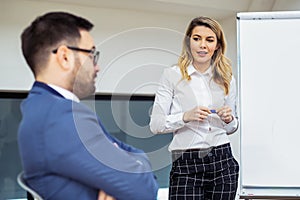 Business colleagues in conference meeting room during presentation