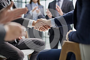 Business colleagues shaking hands in an office hallway