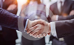 Business colleagues shaking hands in an office hallway