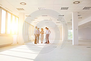 Business colleagues standing while discussing at new office