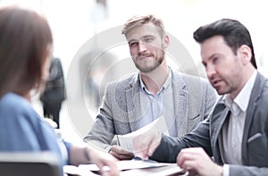 Business colleagues are talking, sitting at the table cafe