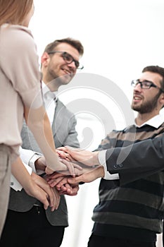 Business colleagues with their hands stacked together