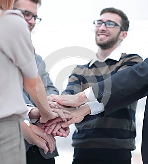 Business colleagues with their hands stacked together