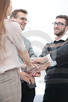 Business colleagues with their hands stacked together