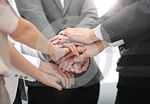 Business colleagues with their hands stacked together