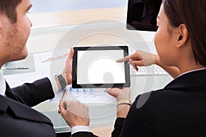 Business colleagues using digital tablet