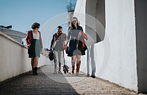 Business colleagues walking together discussing project details in a city