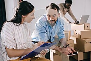 business colleagues working with clipboard during relocation