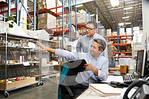 Business Colleagues Working At Desk In Warehouse