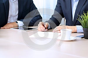 Business colleagues working together. Businessman is signing a contract