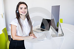 Business, communication, technology and call center concept - friendly female helpline operator with headphones and computer call