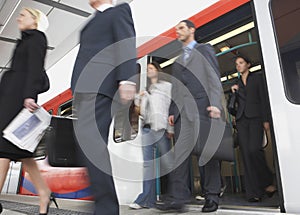 Business Commuters Getting Off Train