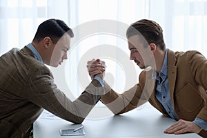 Business competition arm wrestling focused men hands