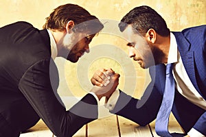 Business competition concept Businessmen arm wrestling in office