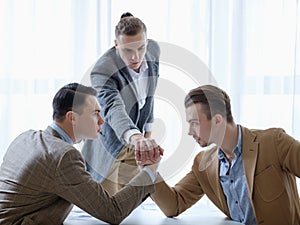 Business competition arm wrestling focused men hands