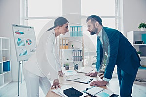 Business competition, side view profile of two colleagues in classy suits having disagreement and conflict, standing in modern