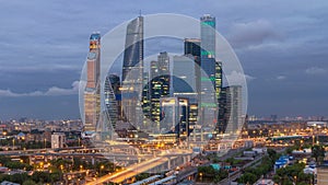 Business complex of skyscrapers Moscow city day to night timelapse. In the foreground the railway and automobile