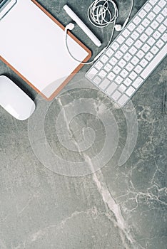 Business composition with white computer keyboard, mouse, clipboard, paper on marble background. Coffee break concept. Top view