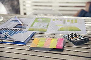 Business computer office desk with annual, summary report, calculator, pencil, and graph place on wooden table, working space at