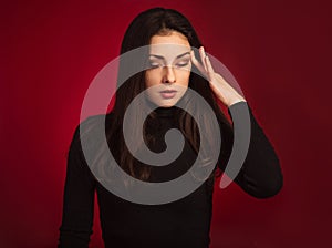 Business concentrate thinking woman find the answer in clever mind with closed eyes with fingers near the face  in black sweater