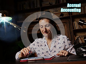 Business concept about Accrual Accounting Business woman, executive manager hand filling paper business document