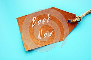 Business concept about Book Now with sign on the piece of paper