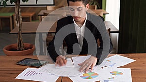 business concept, business arabic young man working and meeting with a chart in the office on his desk, reviewing charts